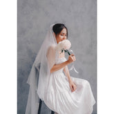 Sleeveless silk organza dress with shirred bodice and tiered hem for effortless elegance